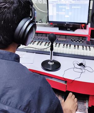 Boy working work on a music production studio